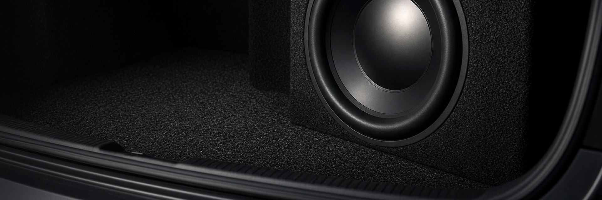 Black unbranded 12-inch subwoofer facing the trunk opening